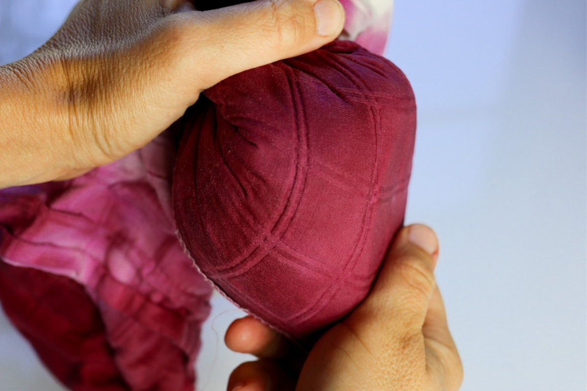 straining blackberry juice through a cloth bag