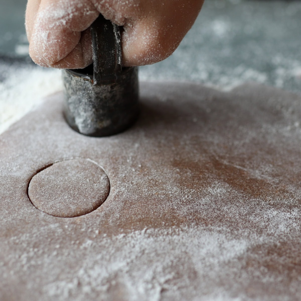 a little hand cutting out chigger snap dough