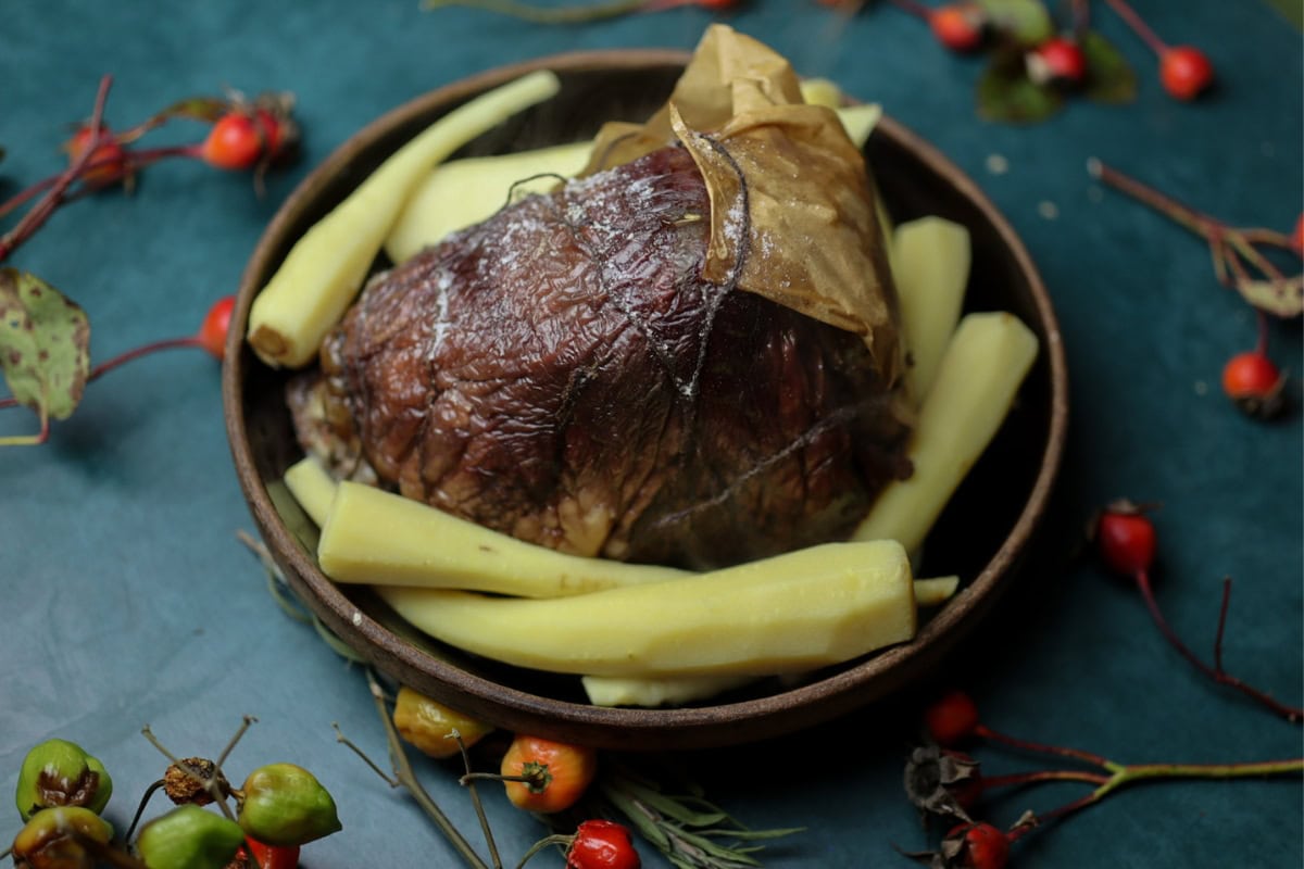 a baked beef heart surrounded by parsnips
