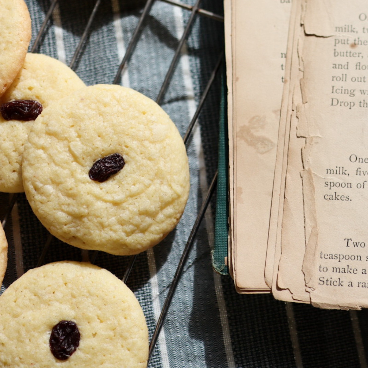 a plate of Connecticut cookies next to an 1800's cook book.