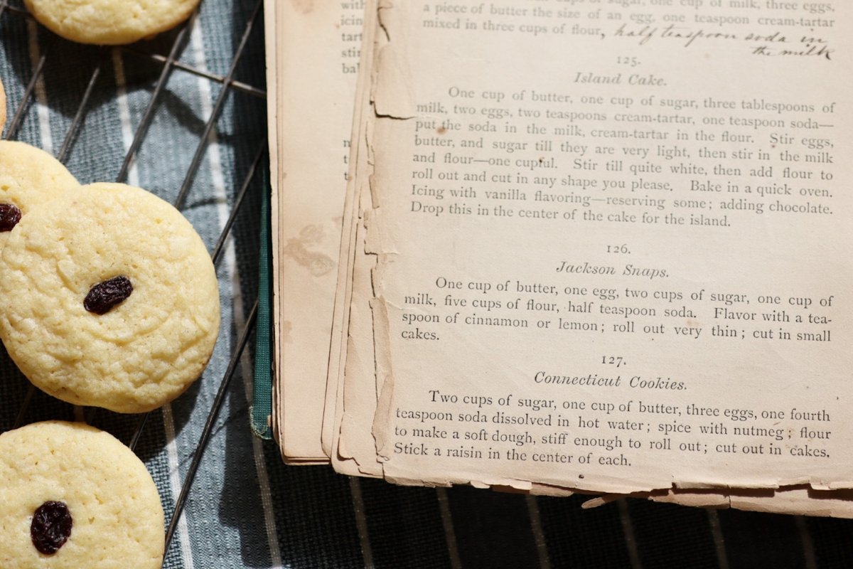 a plate of Connecticut Cookies next to an 1800's cook book