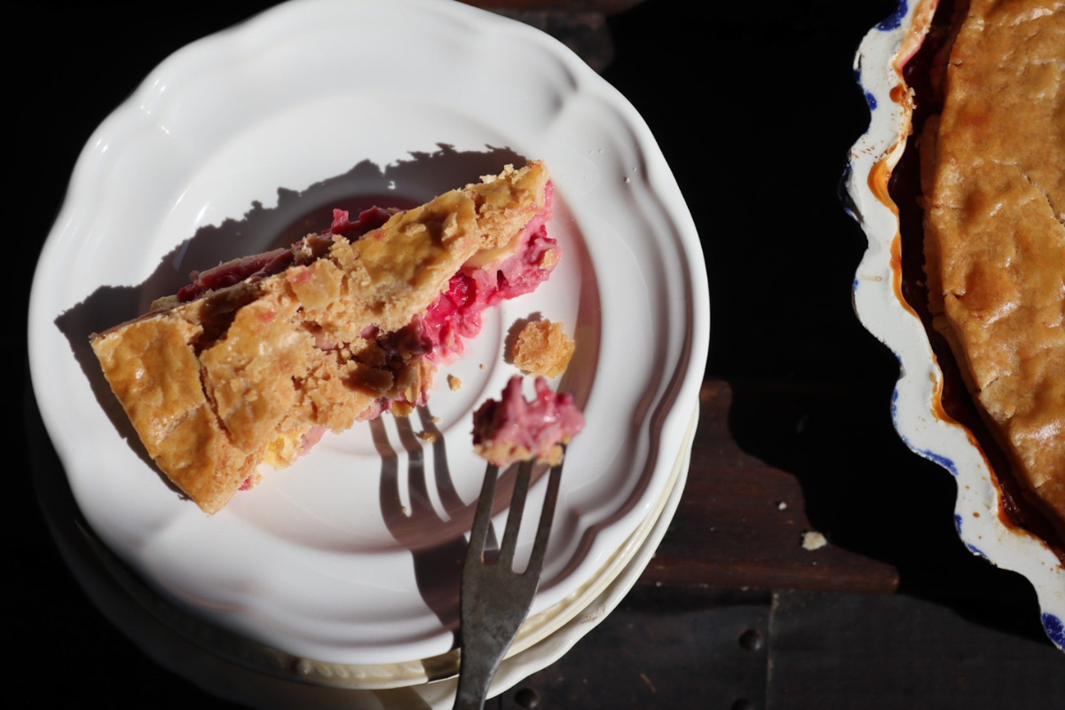 a slice of old fashioned raspberry tart with cream