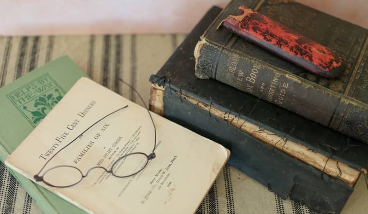 a stack of 1800s cook books