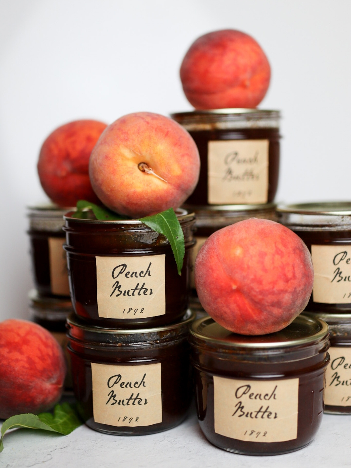 a stack of jars of peach butter