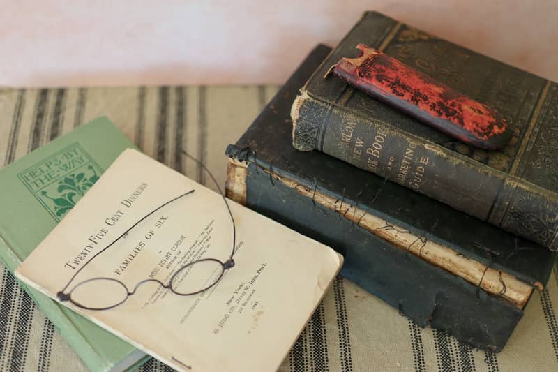 a stack of 1800s cook books